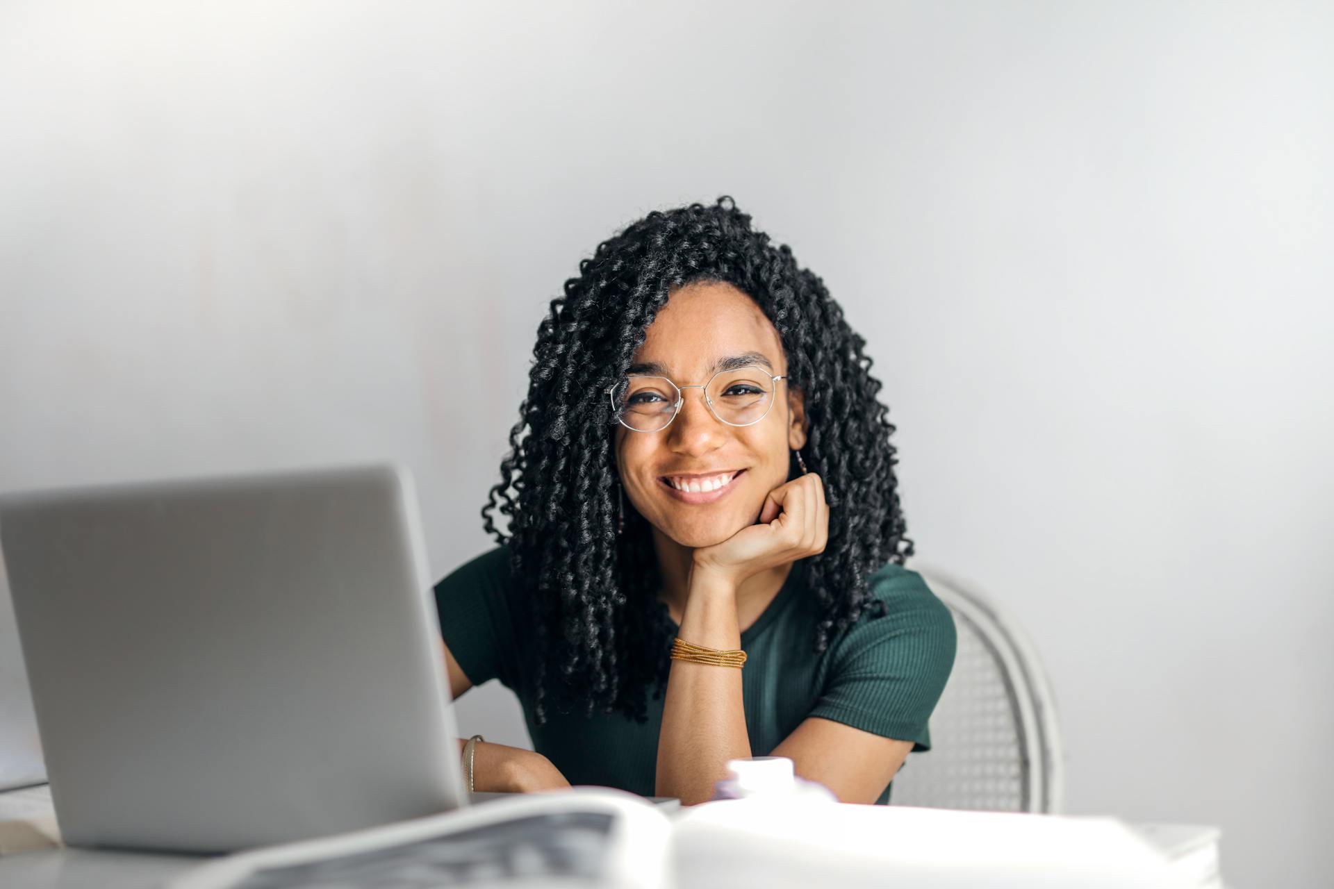 Student smiling at laptop